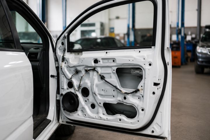 Replacement car door inspected from a wrecked vehicle